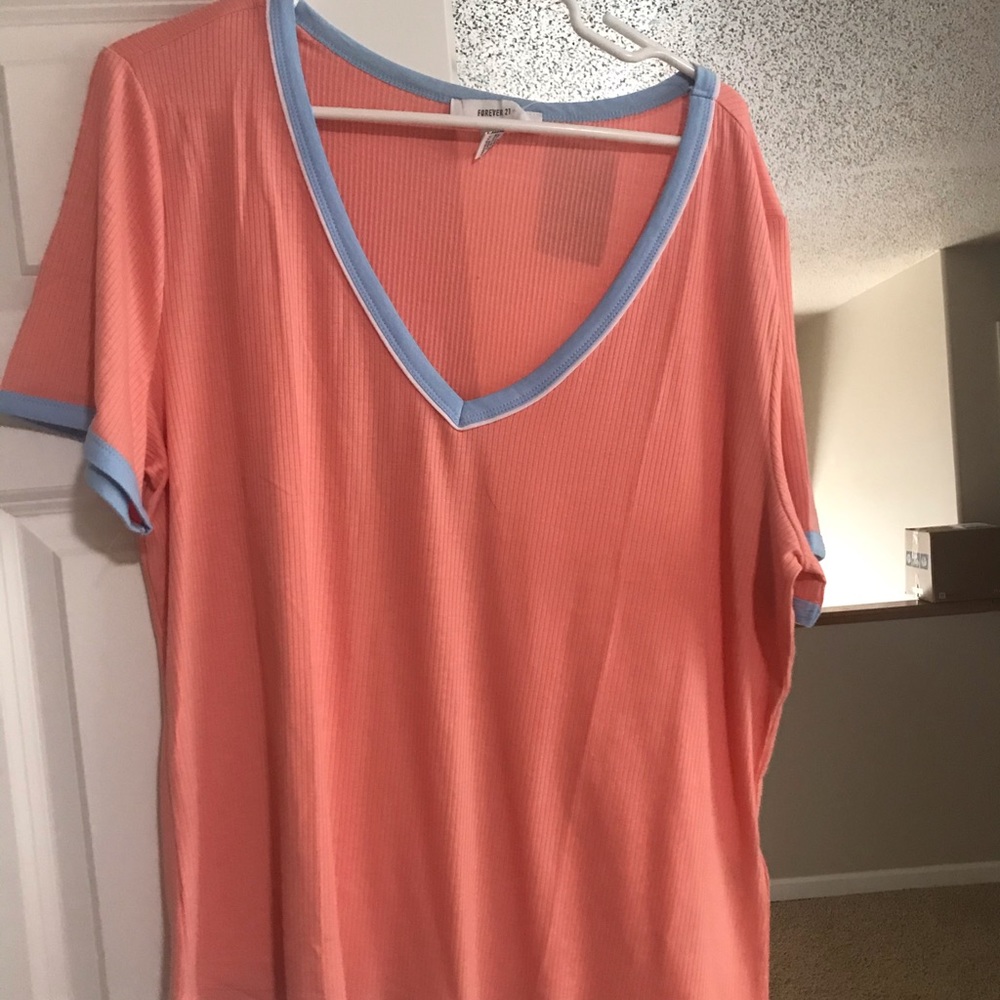 Bright pink v neck tshirt with baby blue accents